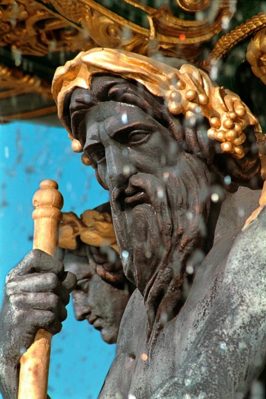 a statue of a man holding a stick, a statue, by Andrea del Verrocchio, flickr, black cyan gold and aqua colors, portrait of zeus, covered in water drops, long black beard