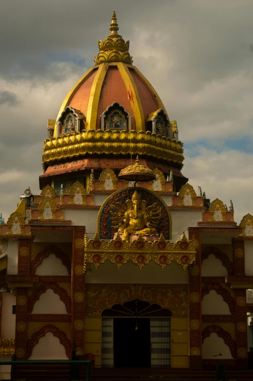 a large building with a golden dome on top of it, inspired by Ram Chandra Shukla, art nouveau, vietnamese temple scene, puṣkaracūḍa, ceremonial clouds, sri lanka