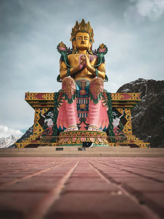 a large statue sitting on top of a red brick floor, pexels contest winner, cloisonnism, breathtaking himalayan landscape, avatar image, colorful architecture, full front view