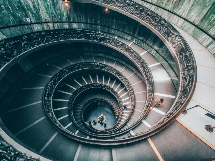 a spiral staircase in the middle of a building, pexels contest winner, neoclassicism, people watching around, roman numerals, da vinci, 🦩🪐🐞👩🏻🦳