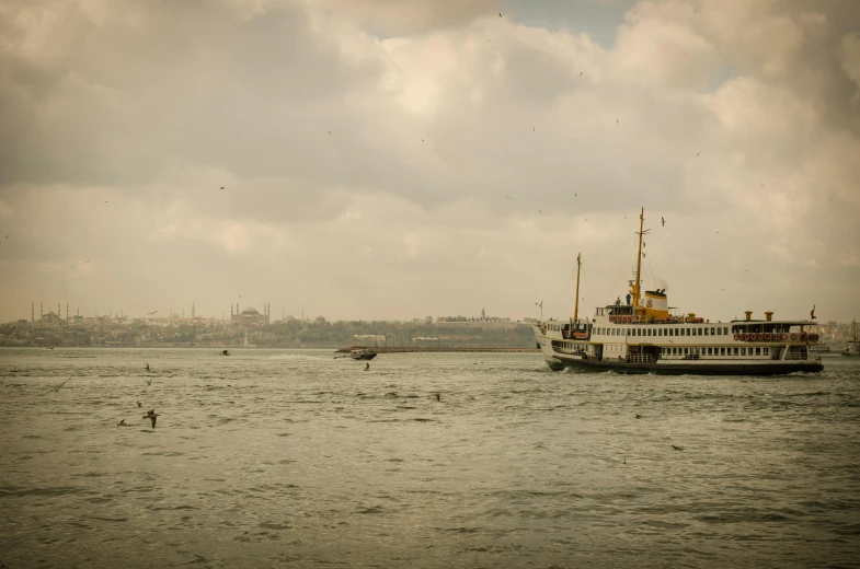 a large boat floating on top of a body of water, by Yasar Vurdem, pexels contest winner, hurufiyya, istanbul, vintage photo, hd footage