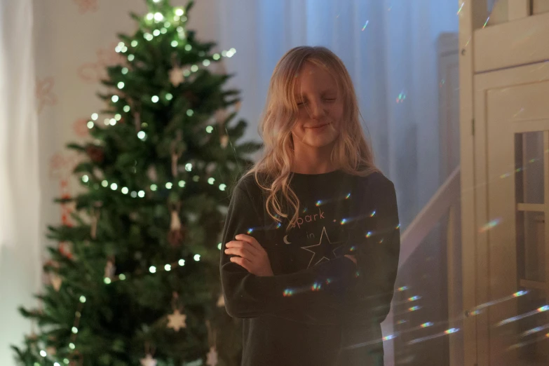 a woman standing in front of a christmas tree, a hologram, inspired by Ernest William Christmas, happening, kids, cosy enchanted scene, black, natural lighting