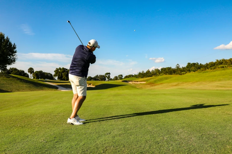 a man swinging a golf club at a golf course, pexels contest winner, “ iron bark, avatar image, sunny day time, bumps