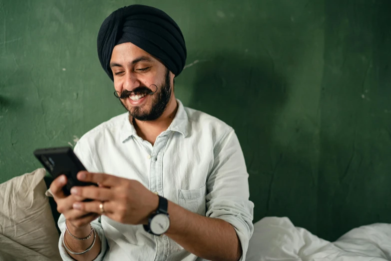 a man sitting on a bed looking at his cell phone, inspired by Manjit Bawa, trending on pexels, renaissance, in a classroom, cheeky smile, australian, thumbnail