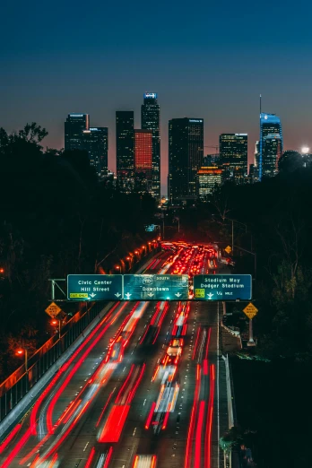 a highway filled with lots of traffic next to tall buildings, unsplash contest winner, renaissance, los angeles at night, city buildings on top of trees, billboard image, tubes