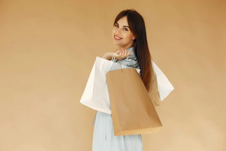 a woman in a blue dress holding a brown paper bag, brown and white color scheme, looking happy, skincare, profile image