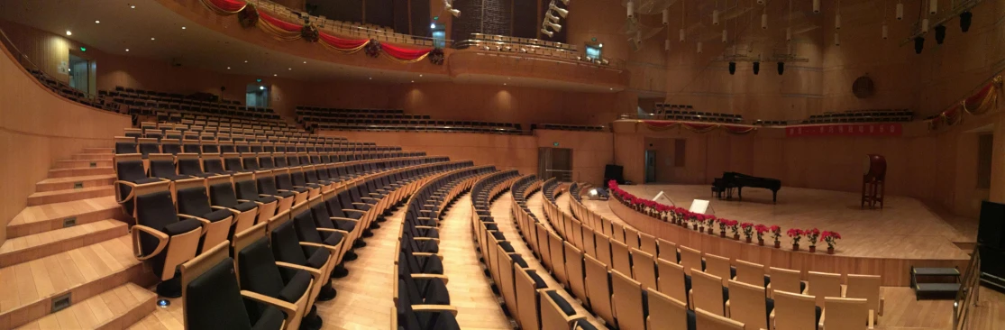 a large auditorium with rows of seats and a piano, seoul, curvy build, in hong kong, sitting in tokyo