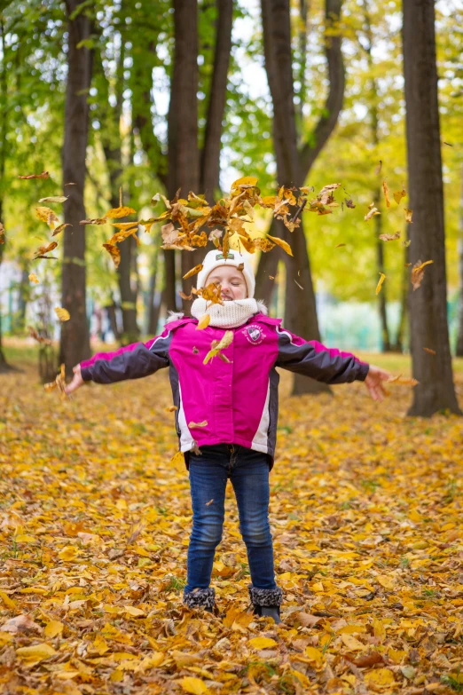 a little girl throwing leaves in the air, a picture, by Sven Erixson, pexels contest winner, model wears a puffer jacket, 15081959 21121991 01012000 4k, an ahoge stands up on her head, ukrainian girl