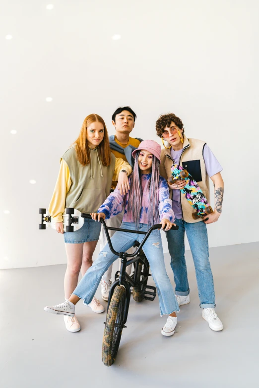 a group of young people posing for a picture, trending on pexels, toyism, she is wearing streetwear, rides a bike, studio photoshot, twilight ray