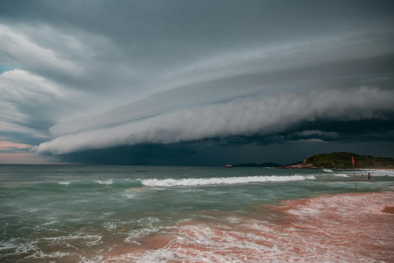 a group of people standing on top of a beach next to the ocean, unsplash contest winner, surrealism, thunderstorm supercell, red sand beach, 3 layers of sky above each other, cotton candy clouds