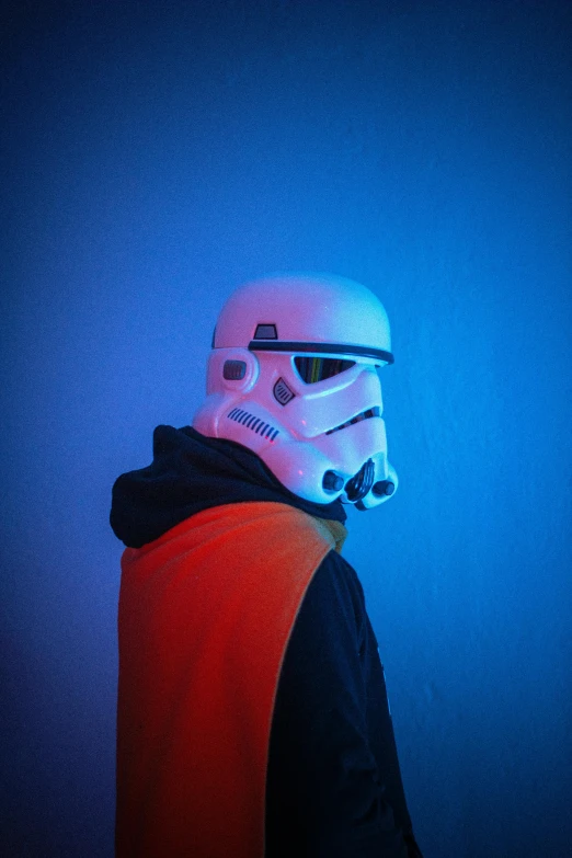 a man wearing a star wars stormtrooper helmet, inspired by Ralph McQuarrie, unsplash, holography, wearing shoulder cape, intense colours, cinematic outfit photo, joep hommerson