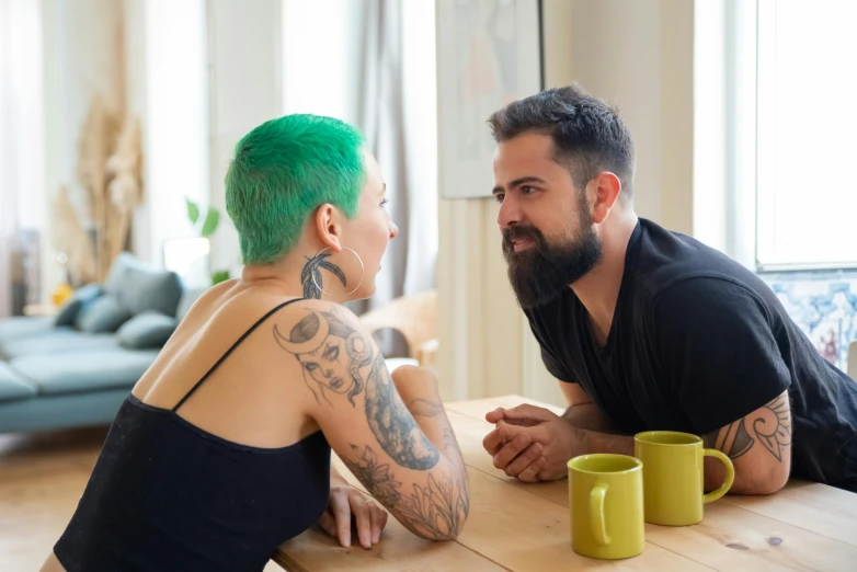 a man and a woman sitting at a table, pexels contest winner, short green hair, tattooed man, on a coffee table, profile image