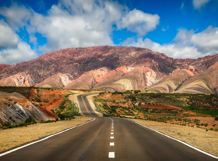 an empty road with mountains in the background, by Julia Pishtar, les nabis, multicoloured, red sand, slide show, thumbnail