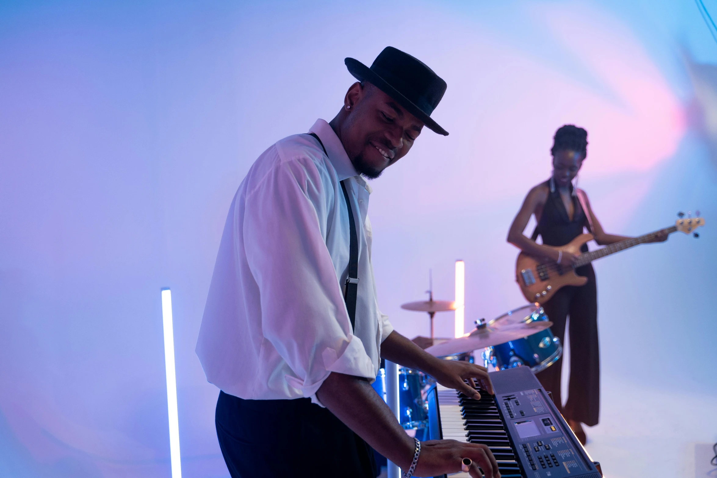 a man standing next to a keyboard on a stage, inspired by Richard Wright, pexels, funk art, avatar image, taken with sony alpha 9, musicians playing instruments, romantic lead