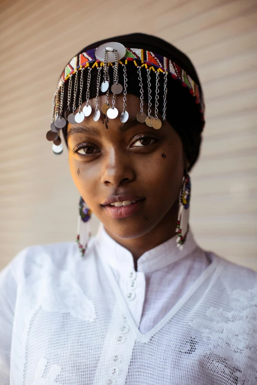 a close up of a person wearing a headdress, inspired by Afewerk Tekle, black teenage girl, somali attire, madagascar, multiple stories