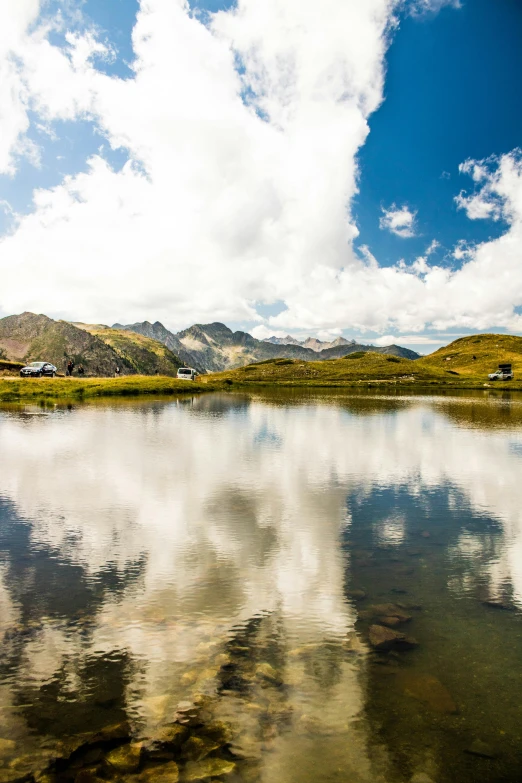 a body of water with mountains in the background, by Werner Andermatt, les nabis, small lake, mirrors, alp