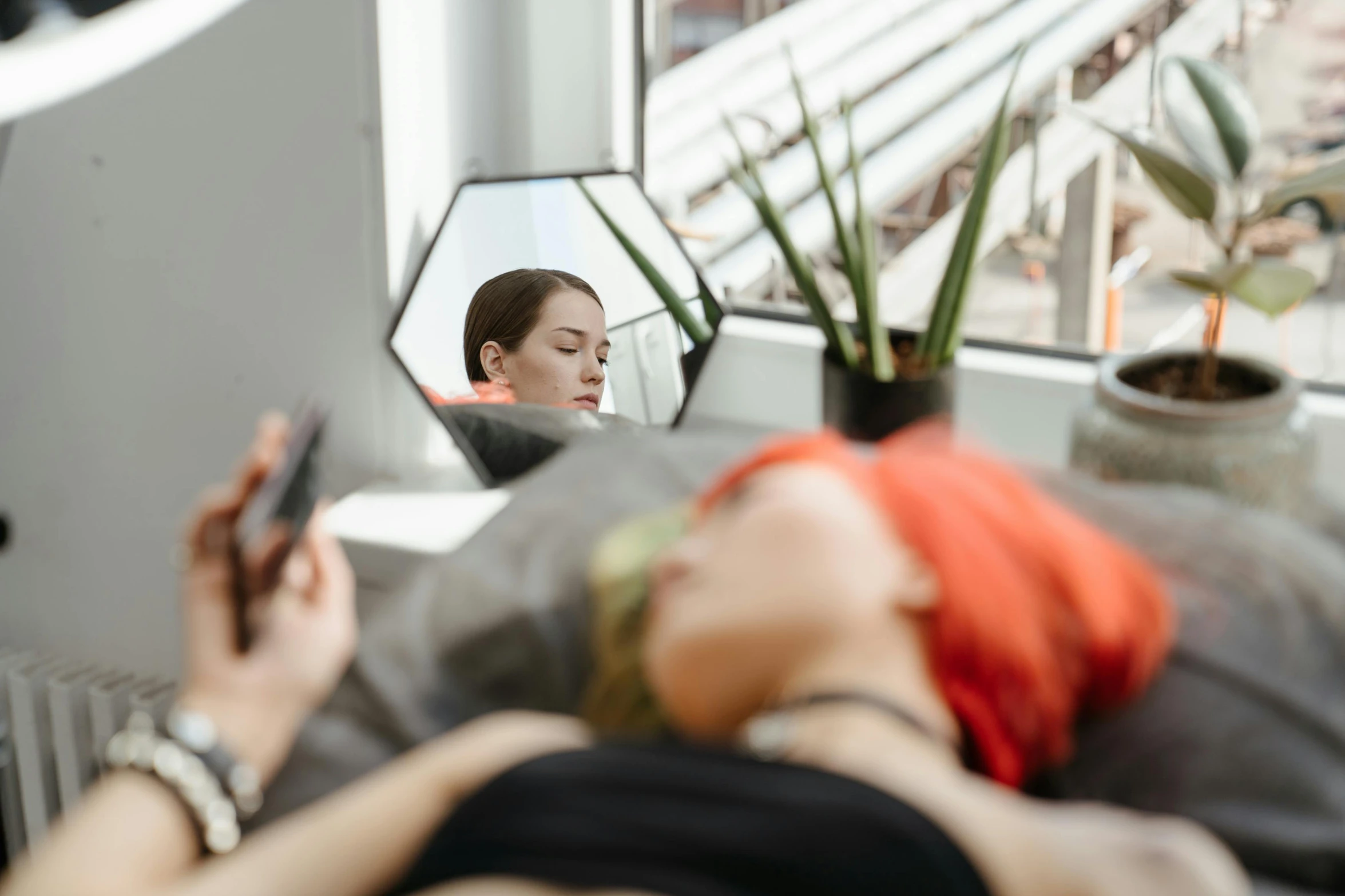 a woman taking a picture of herself in a mirror, trending on pexels, hyperrealism, humans sleeping in healing pods, she is laying on her back, woman with red hair, acupuncture treatment