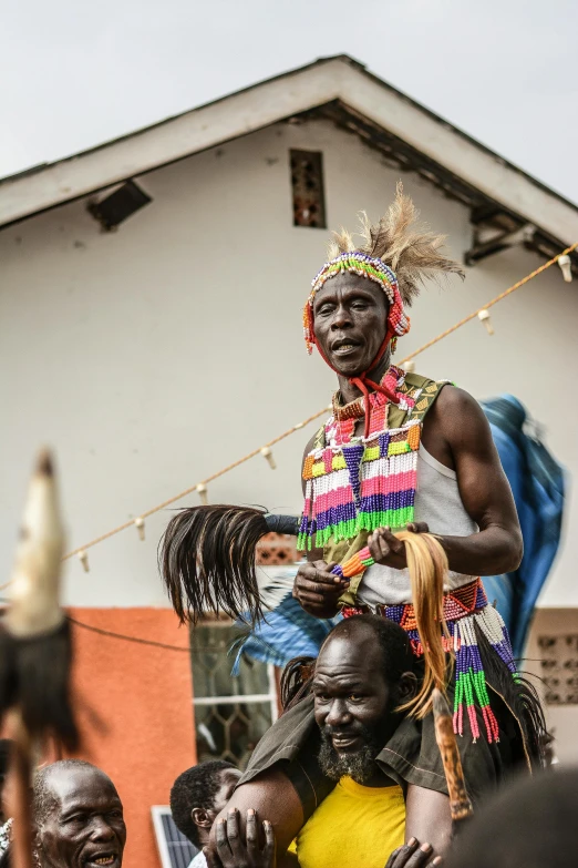 a man riding on the back of a horse, by Ingrida Kadaka, happening, holy ceremony, multi - coloured, an ahoge stands up on her head, portrait photo