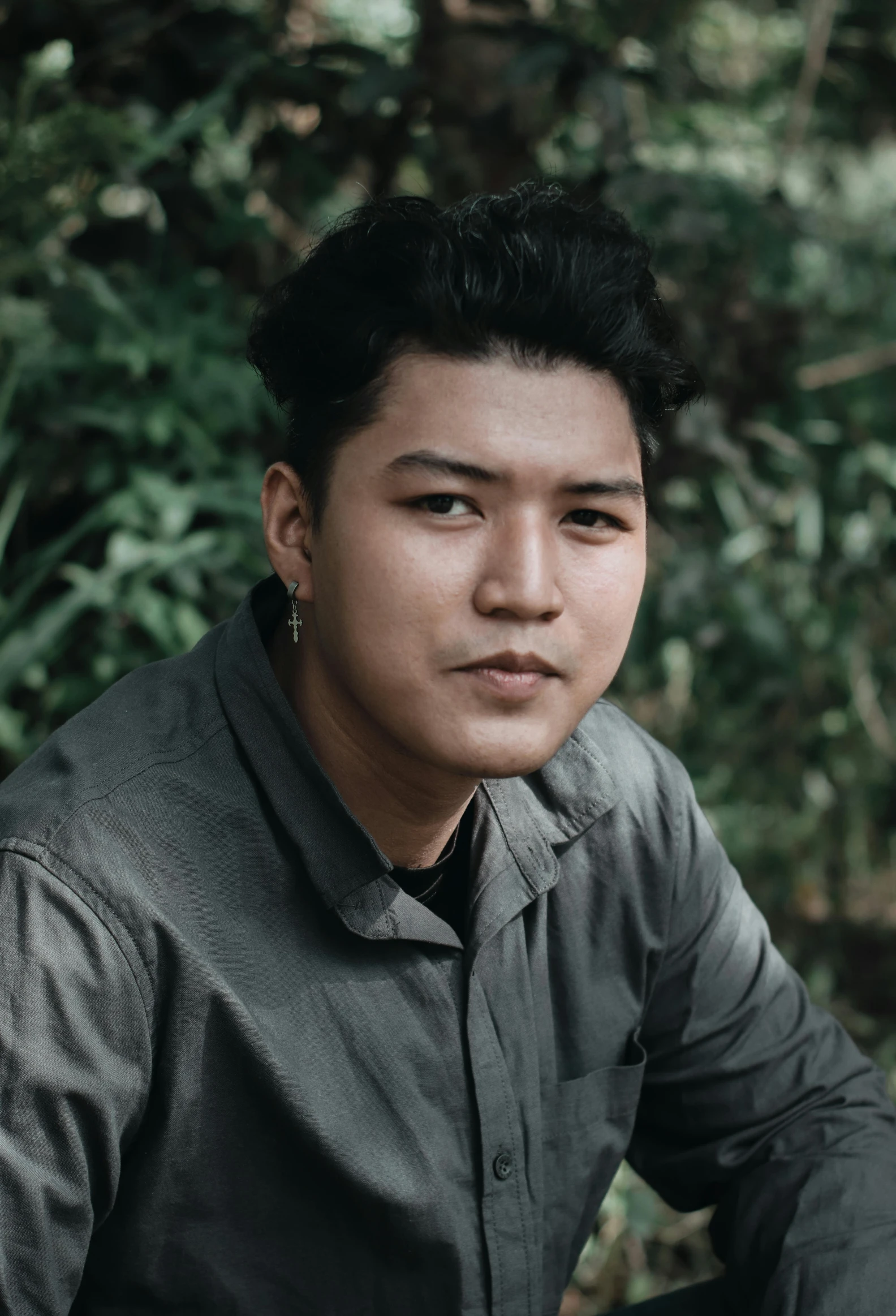 a man sitting on top of a wooden bench, an album cover, inspired by Rudy Siswanto, unsplash, sumatraism, portrait of forest gog, closeup headshot portrait, non-binary, lush surroundings