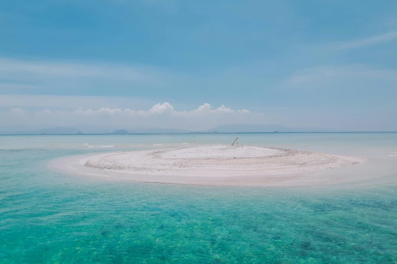 a small island in the middle of the ocean, unsplash contest winner, land art, white sarong, sparsely populated, philippines, white cyan