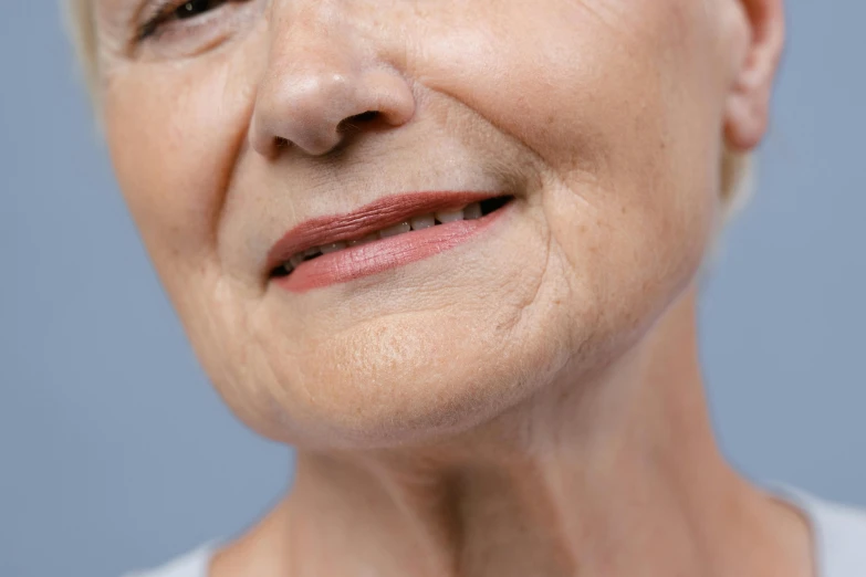 a close up of a person with a tooth brush, slightly round chin, wrinkly, profile image, elderly woman