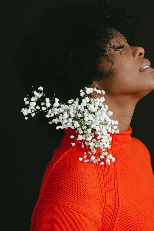 a woman with a bunch of baby's breath flowers on her head, inspired by Carrie Mae Weems, trending on unsplash, aestheticism, long orange sweatshirt, wearing turtleneck, woman's profile, vase with flowers