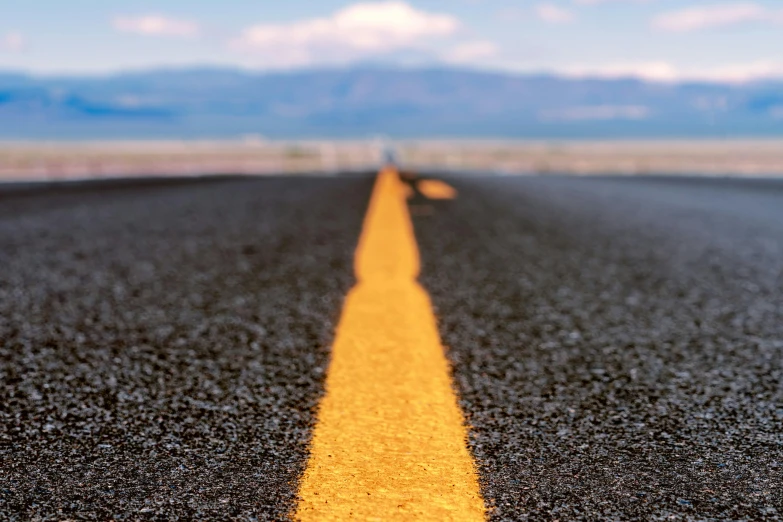 a yellow line in the middle of a road, an album cover, unsplash, photorealism, death valley, thumbnail, ready to eat, rigorous
