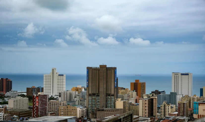 a view of a city from the top of a building, by Daniel Lieske, pexels contest winner, hyperrealism, south african coast, buffalo, partly cloudy day, slide show