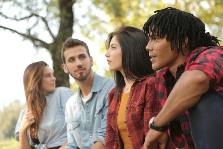 a group of young people sitting next to each other, pexels, renaissance, looking across the shoulder, against the backdrop of trees, mixed race, 15081959 21121991 01012000 4k