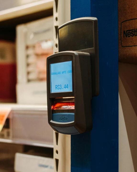 a close up of a machine in a store, sitting on a store shelf, thumbprint, nfts, system unit