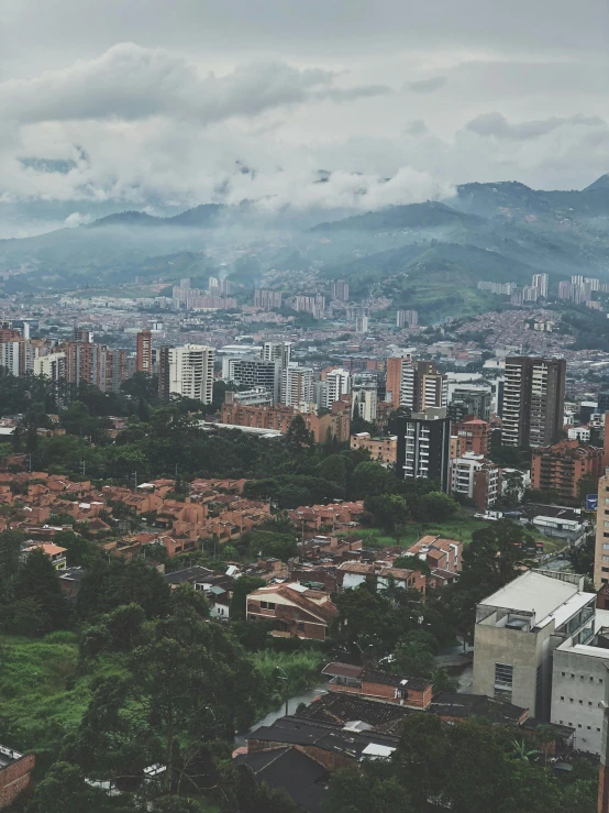 a view of a city from the top of a hill, by Alejandro Obregón, overcast skies, karolina cummings, background image, university