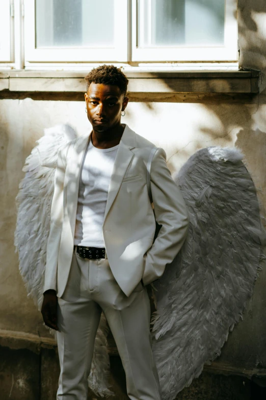 a man in a white suit and angel wings, inspired by Paul Georges, donald glover, modelling, grey skinned, cupid