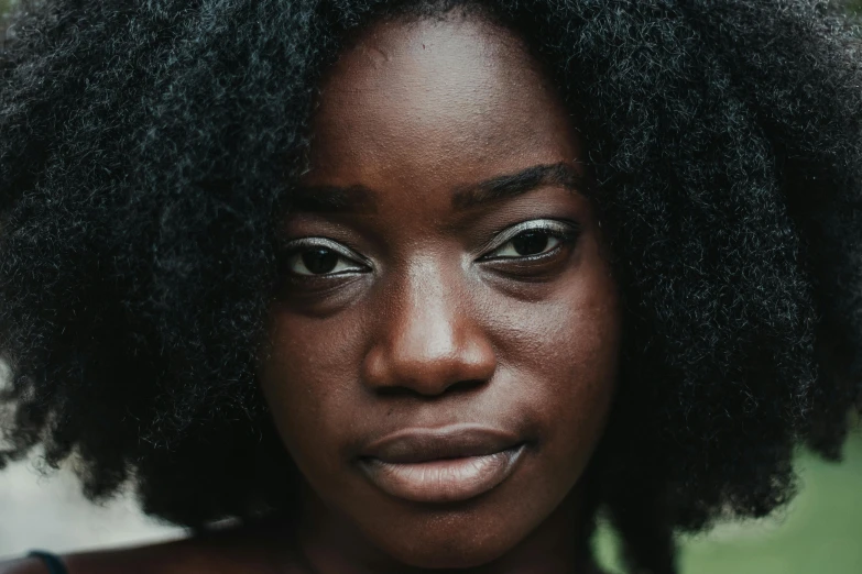 a close up of a person with an afro, trending on pexels, charcoal skin, women's faces, heavy brow, ( ( dark skin ) )