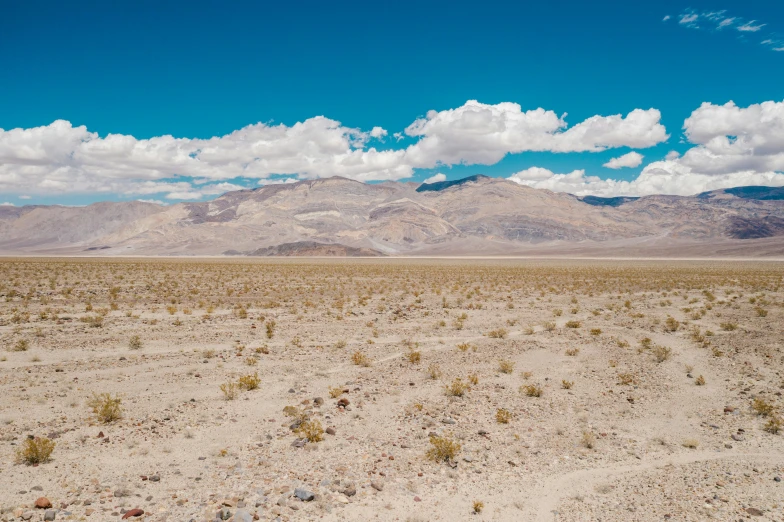 a desert landscape with mountains in the distance, by Ryan Pancoast, unsplash contest winner, land art, background image, stephen shore, 2000s photo