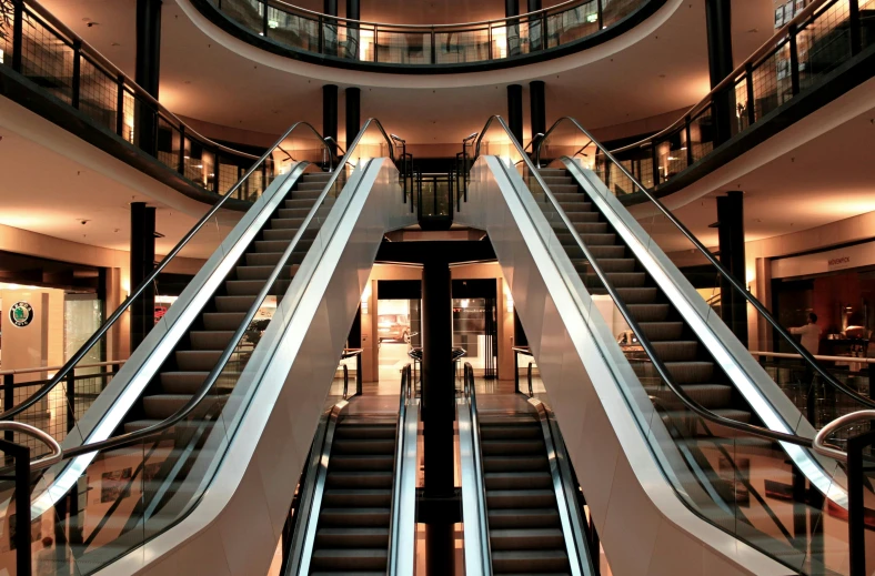 a couple of escalators that are in a building, a screenshot, pexels contest winner, best of retail, multiple levels, ilustration, image in center