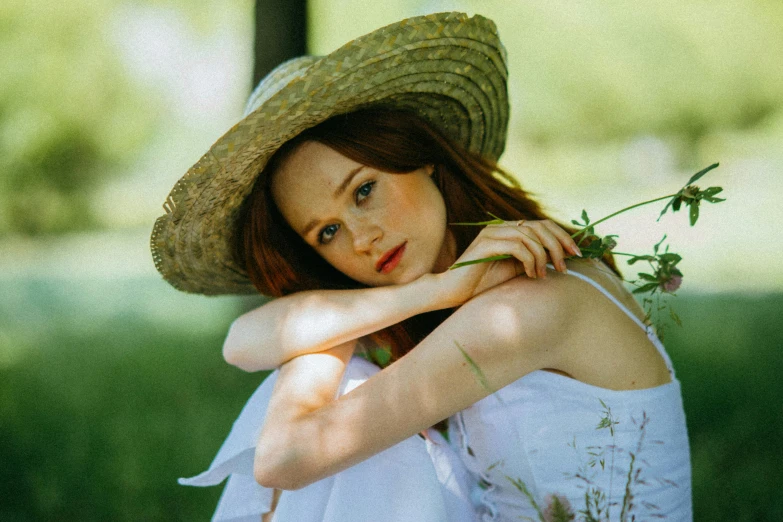 a woman in a straw hat sitting in the grass, an album cover, inspired by Konstantin Somov, pexels contest winner, renaissance, ellie bamber, gorgeous kacey rohl, an all white human, portrait image