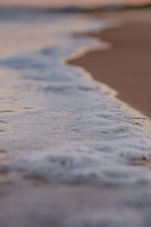 a close up of a wave on a beach, unsplash, conceptual art, soft light - n 9, modeled, detailed photo 8 k, summer evening