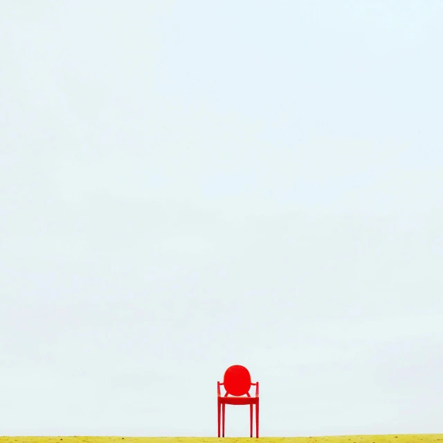 a red chair sitting on top of a grass covered field, a minimalist painting, by Jean-Yves Couliou, unsplash contest winner, postminimalism, ffffound, concert, red yellow, sergey krasovskiy