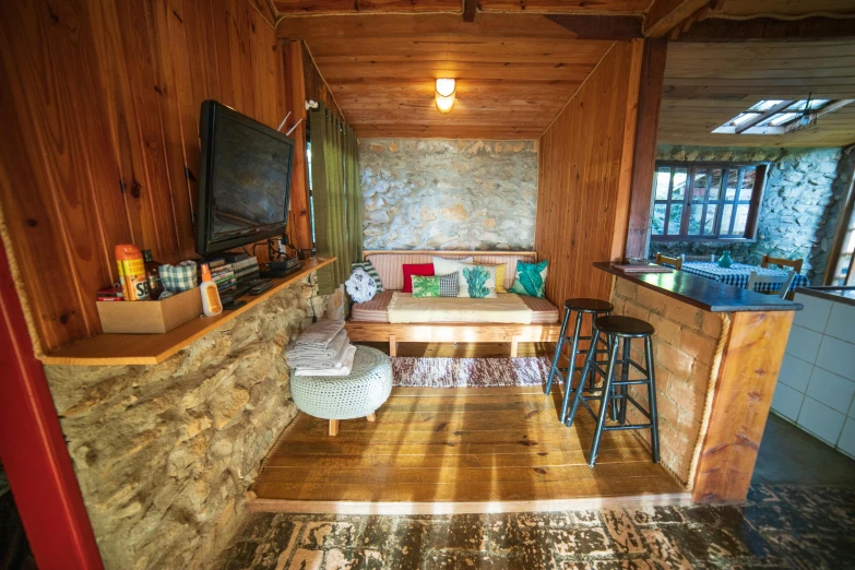 a living room filled with furniture and a flat screen tv, private press, inside primitive hut, bird view, abel tasman, cottagecore hippie