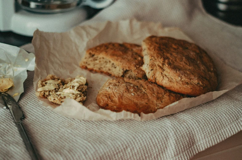 a close up of a plate of food on a table, breads, parchment, cosy vibes, cracked