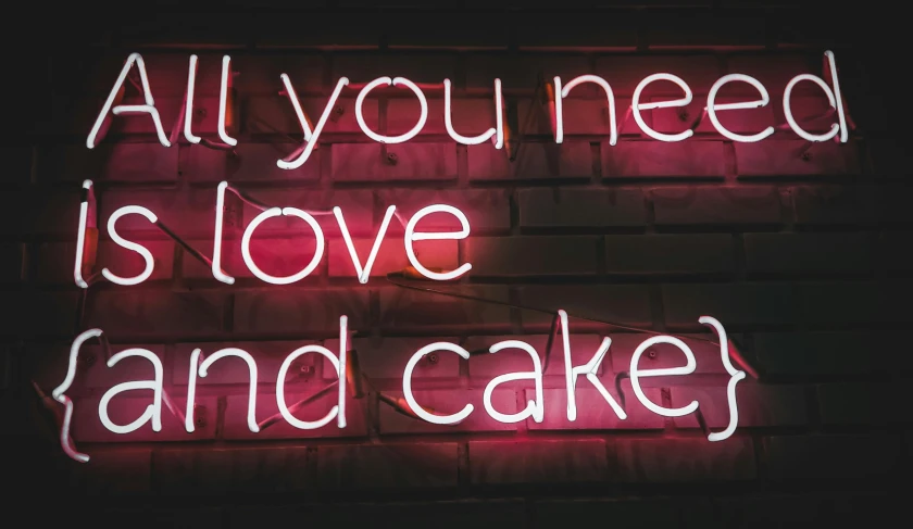 a neon sign that says all you need is love and cake, trending on pexels, kek, well list, foil, you know