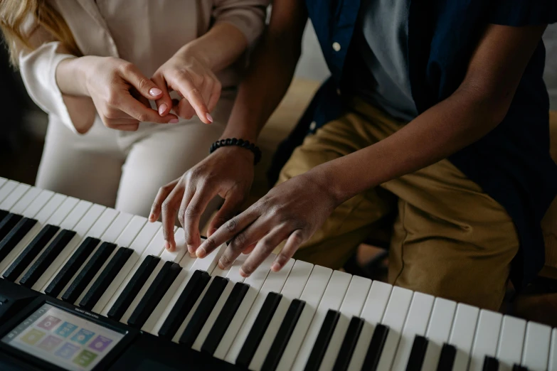 a couple of people that are playing a piano, trending on pexels, school class, with fingers, diverse, thumbnail