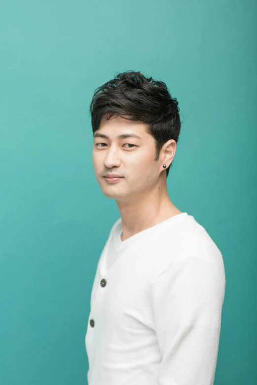 a man standing in front of a blue background, an album cover, inspired by Joong Keun Lee, headshot profile picture, on clear background, ethnicity : japanese, actor