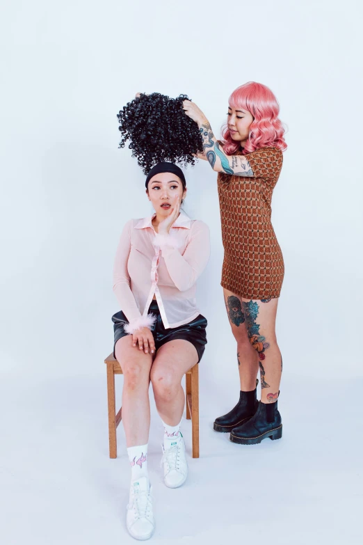 a couple of women sitting next to each other, an album cover, inspired by Wang Duo, trending on pexels, curly pink hair, sitting on a stool, shaved sides, zeen chin and farel dalrymple