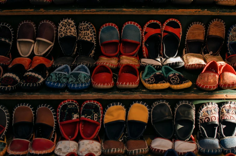 a shelf filled with lots of different types of shoes, pexels, mingei, indigenous art, avatar image, slippers, hand made