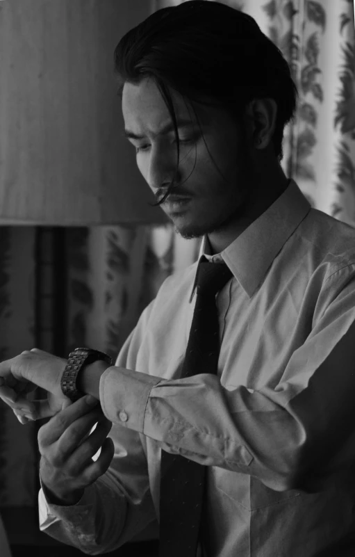 a black and white photo of a man adjusting his tie, reddit, visual art, avan jogia angel, holding gold watch, film noir style, uploaded