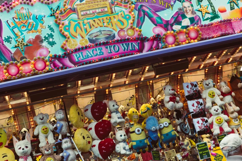 a carnival filled with lots of stuffed animals, by Emanuel Witz, pexels contest winner, award winning shopfront design, still from despicable me 2010, fruit machines, winning photograph