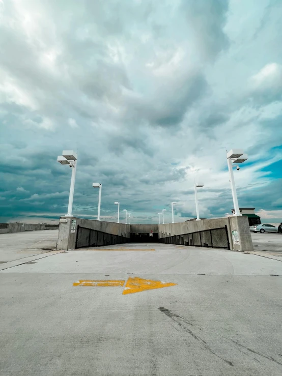 an empty parking lot under a cloudy sky, an album cover, by Carey Morris, unsplash, happening, airport, gateway, ultrawide image