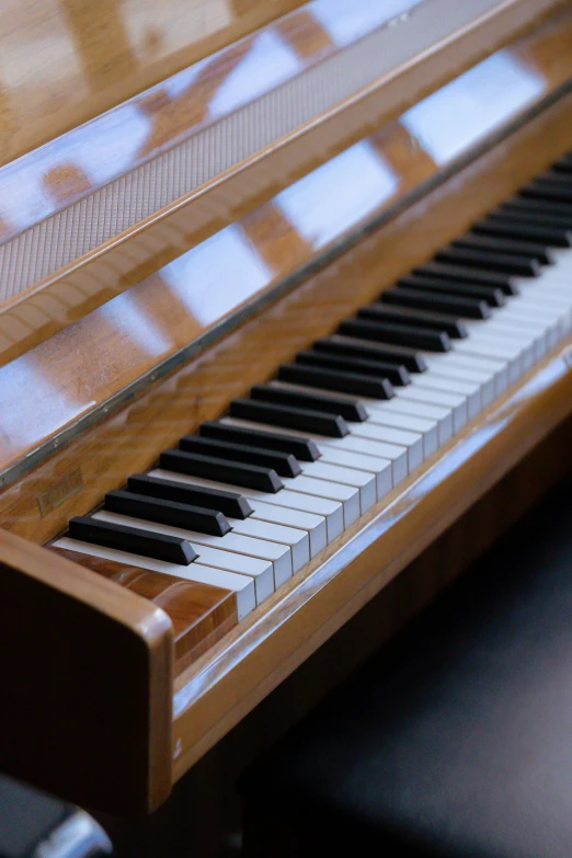 a piano sitting on top of a wooden table, brown, smooth edges, high-body detail, caramel