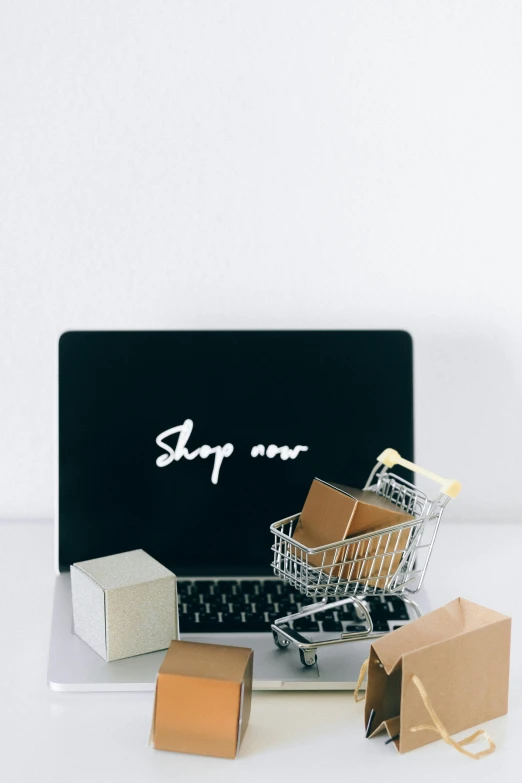 a laptop computer sitting on top of a white table, shopping groceries, thumbnail, cardboard, decoration